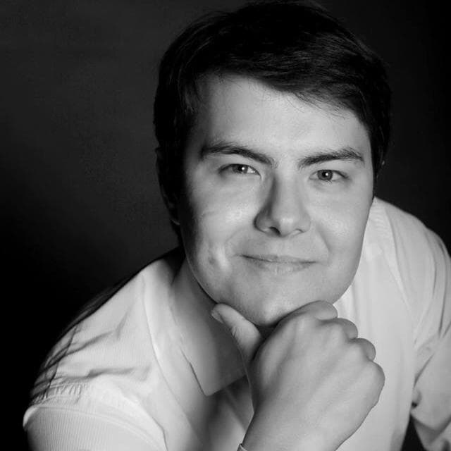 Alibek Ismankulov, founder of Rocket GMAT, resting his chin on his hand